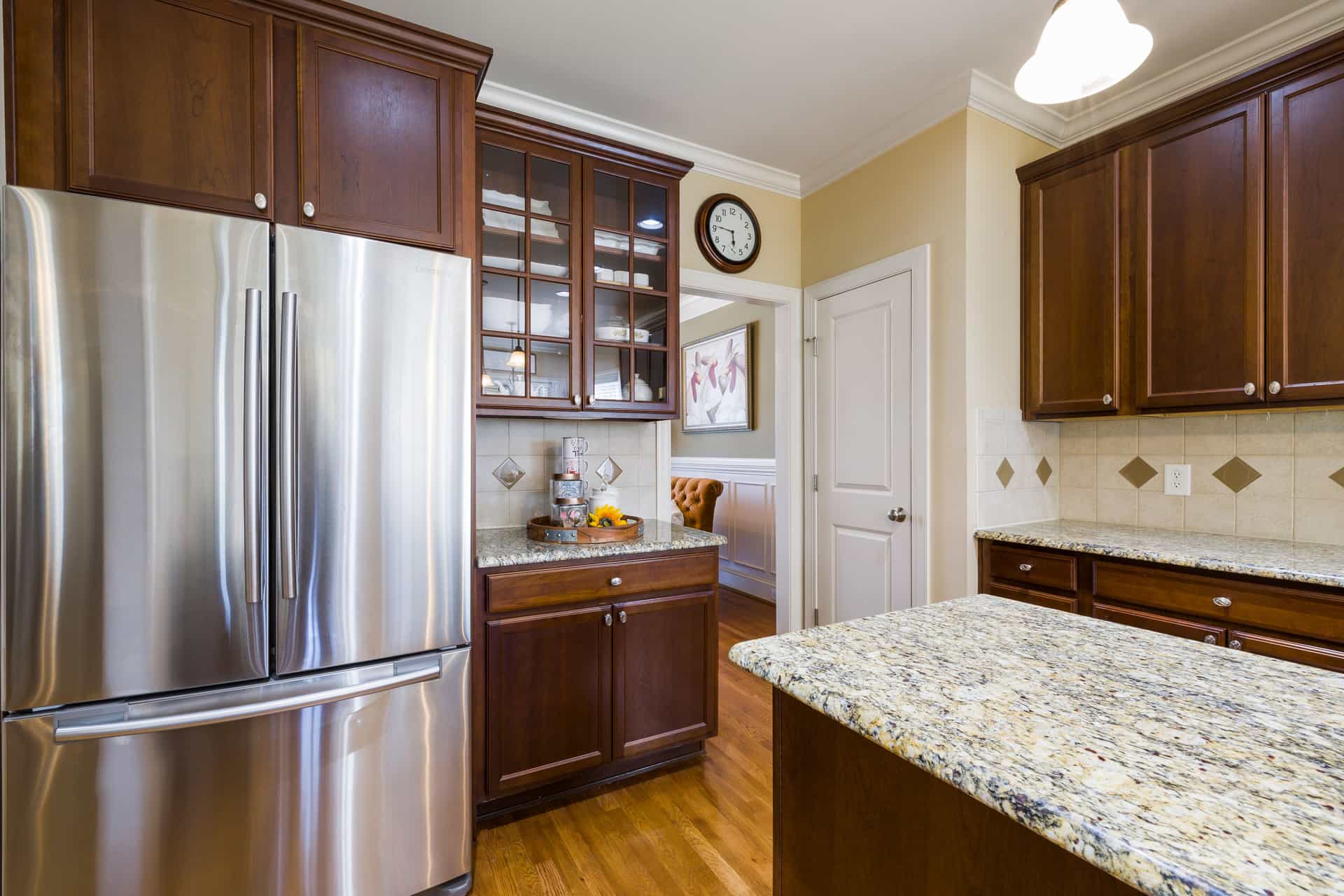 A kitchen with a large refrigerator and granite counters (illustrative photo)